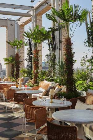 Empty tables ready for service on the outside terrace of the rooftop restaurant Seabird