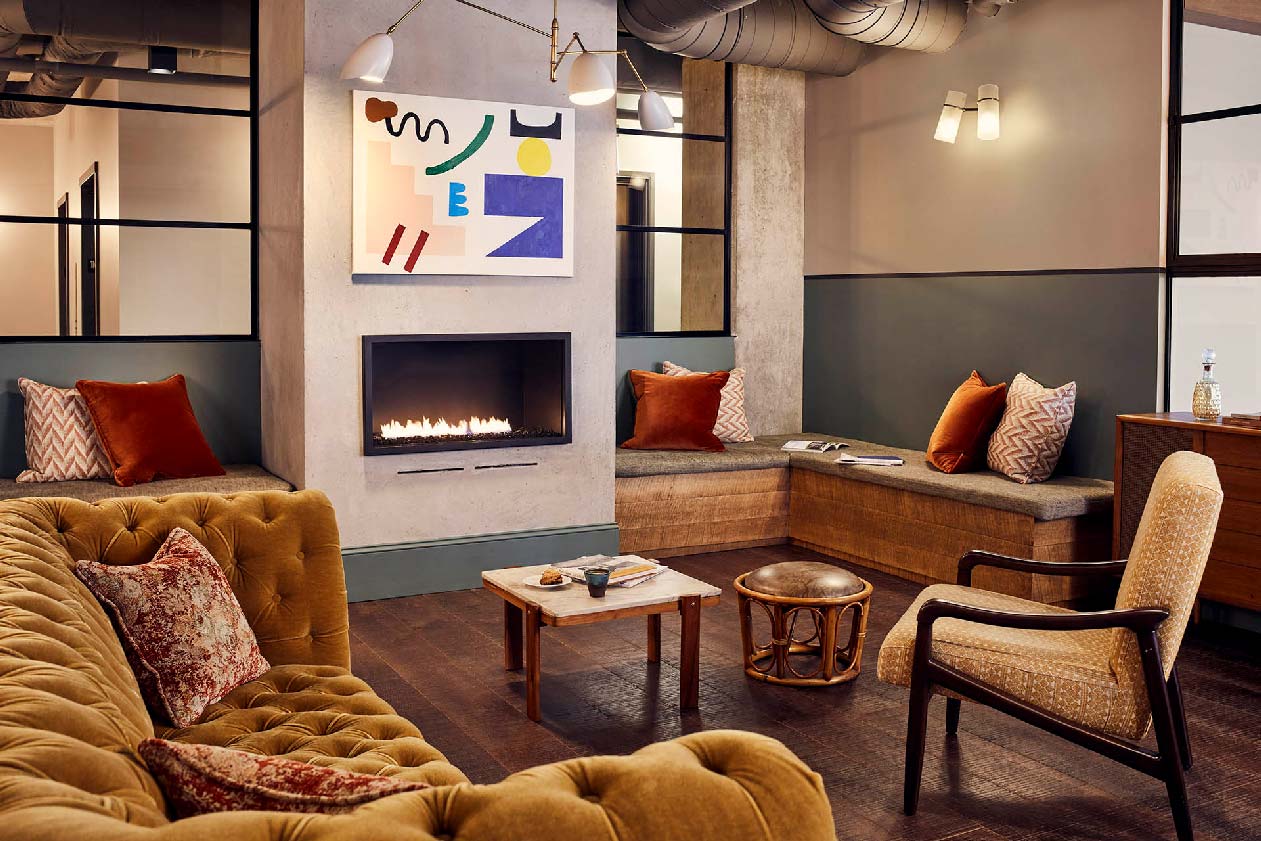 Lounge area with comfortable seating and a fireplace, available for event hire