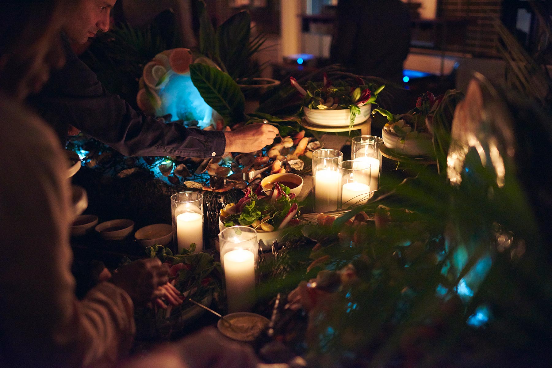 Table setting at a party at night, full of candles