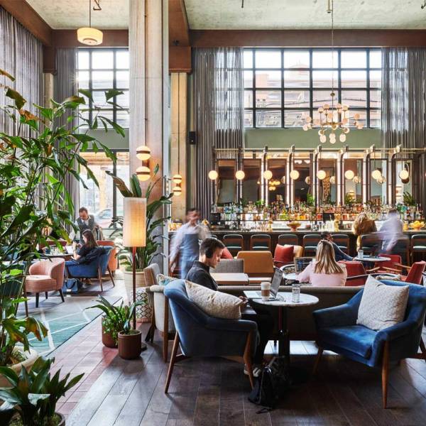 Guests on laptops or meeting friends for a drink in the hotel lobby