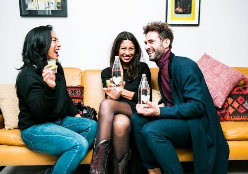 Three friends having fun with drinks