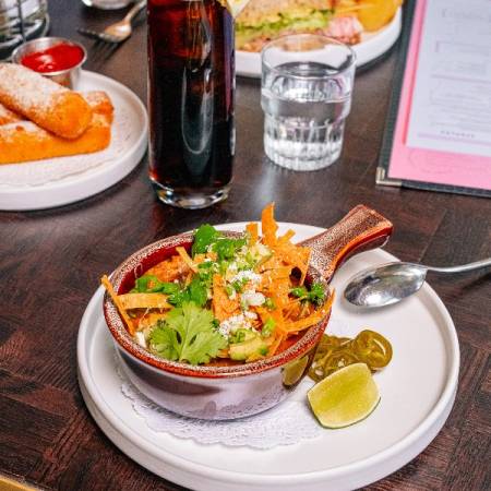 Moonlarks table with a delicious dish and soft drink.