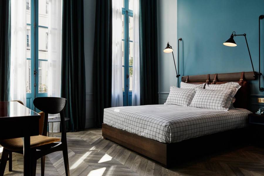 Bedroom in Paris hotel with teal walls