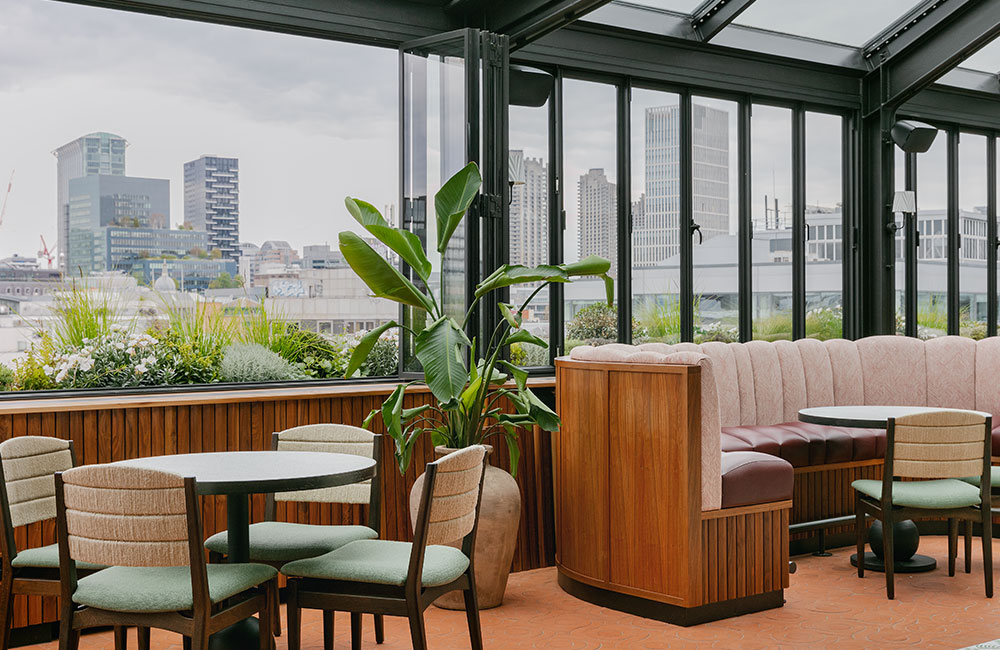 View of high rise buildings in East London out of the window behind restaurant tables