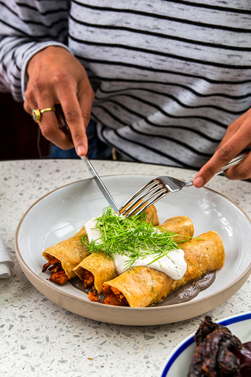 Guest about to eat enchiladas