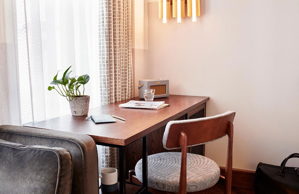 Bright desk area with plant and Roberts Radio