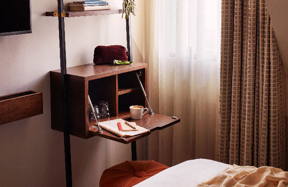 A small fold-down desk area, with backless chair