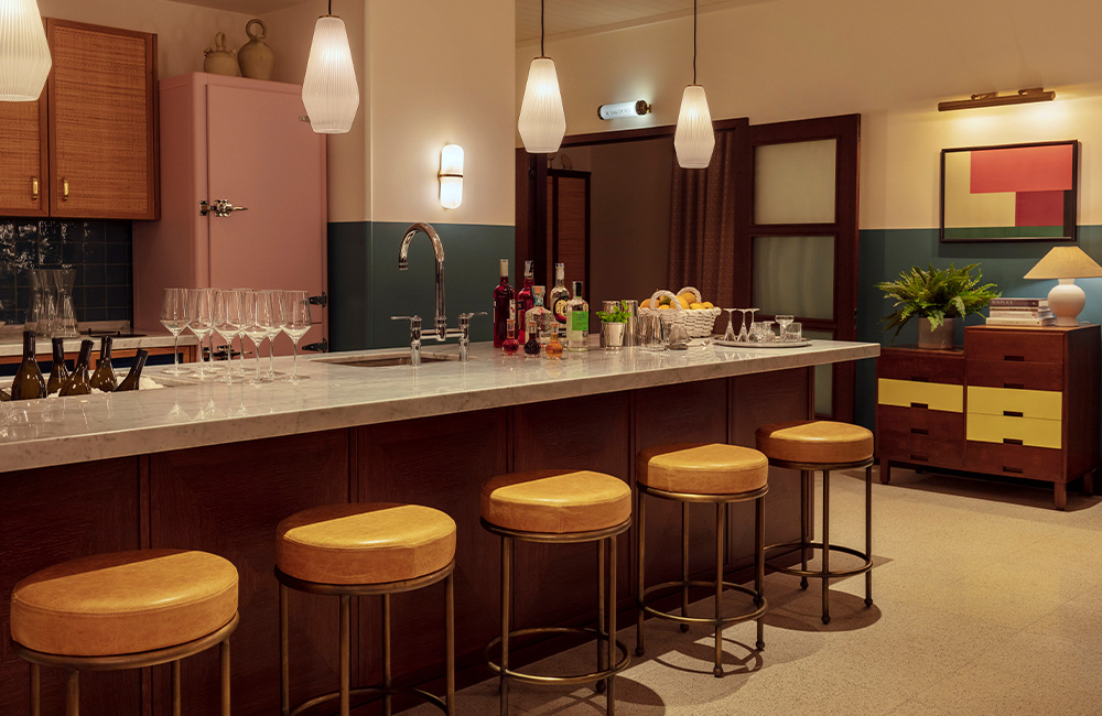 view of the pantry, and counter with bar chairs on the side.
