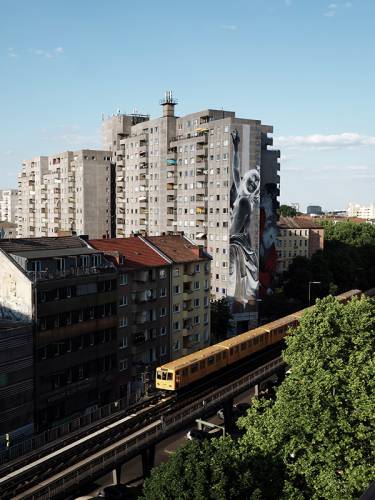 A train runs past some tall apartment buildings in Berlin
