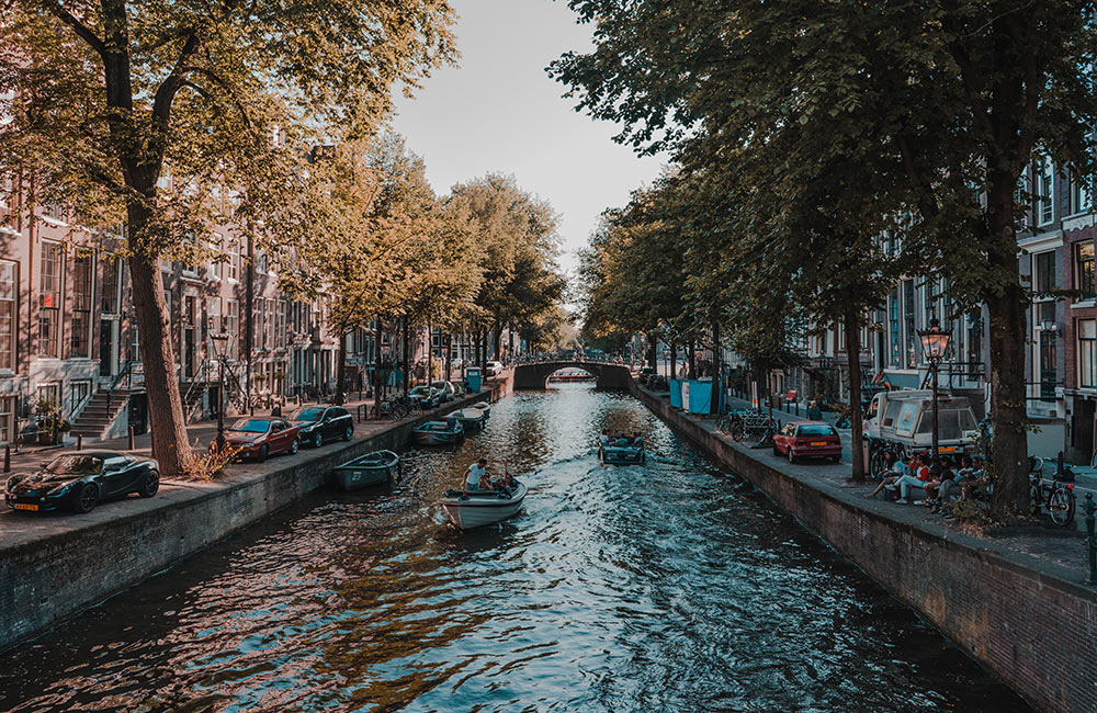 People on boats on a canal in Amsterdam