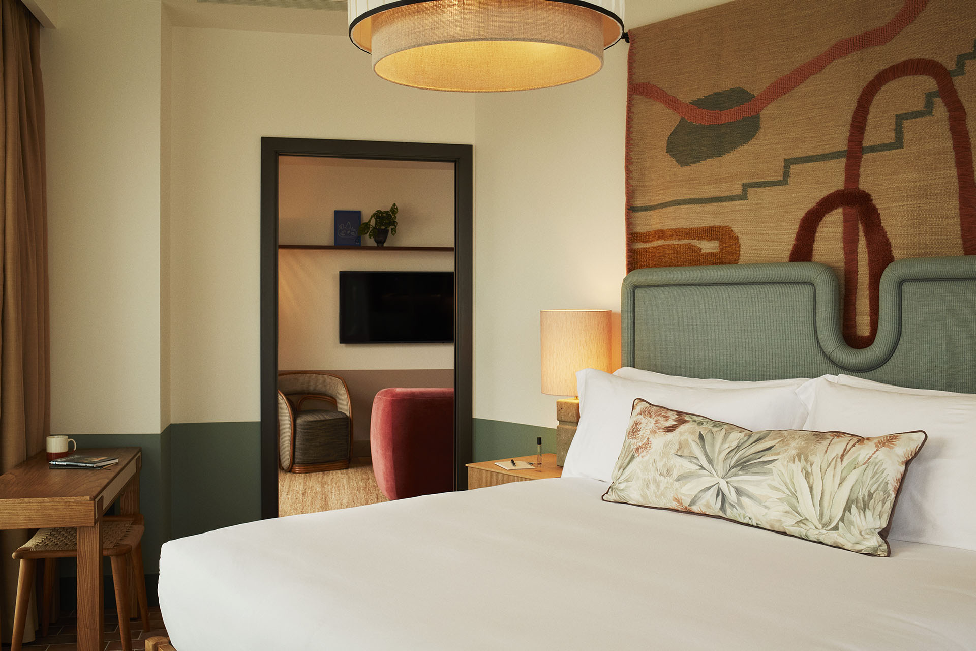 The bedroom is off the lounge area, and has a large double bed and a desk for writing