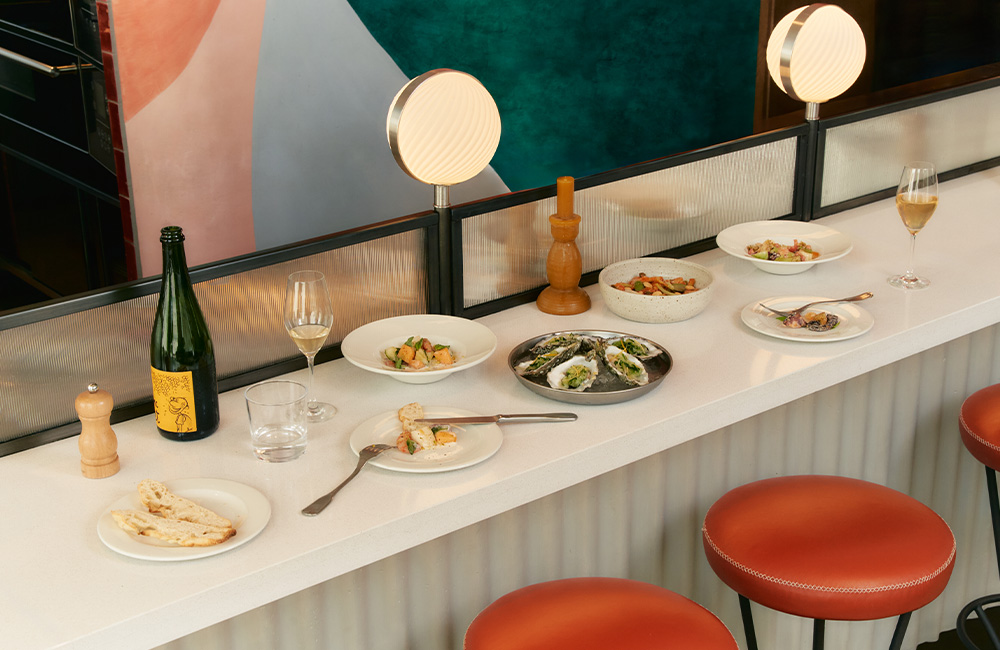 Bar table with a whole spread of different Italian mains, sides and drinks.