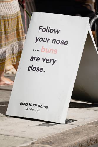 Sign outside Buns from Home reads Follow Your Nose Buns Are Very Close