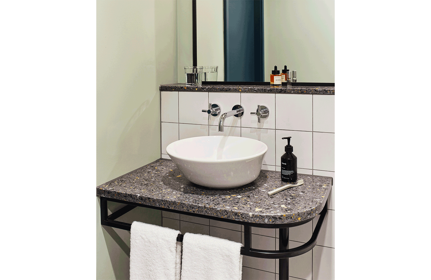 Artistic sink with Blank-brand toiletries and towels at the Hoxton, Shepherd's Bush hotel in London.