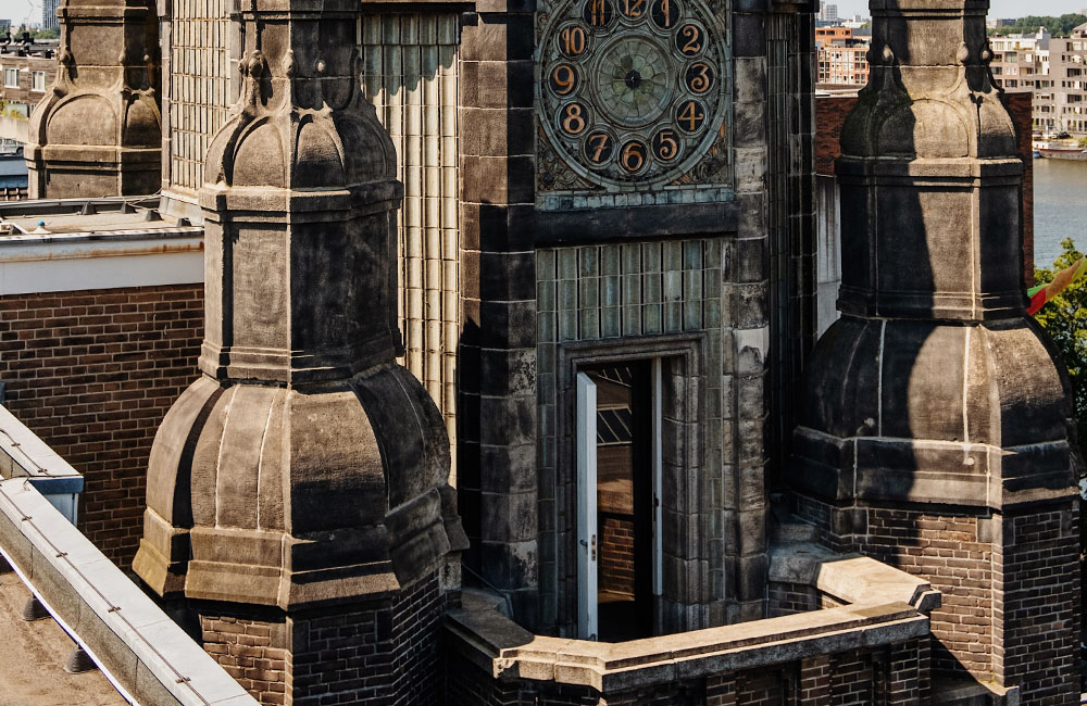 Exterior view of a hotel tower room with a balcony overlooking the city.