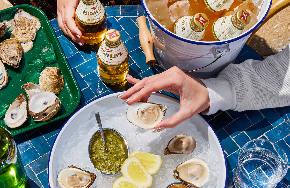 Oysters and beer served on beds of ice.