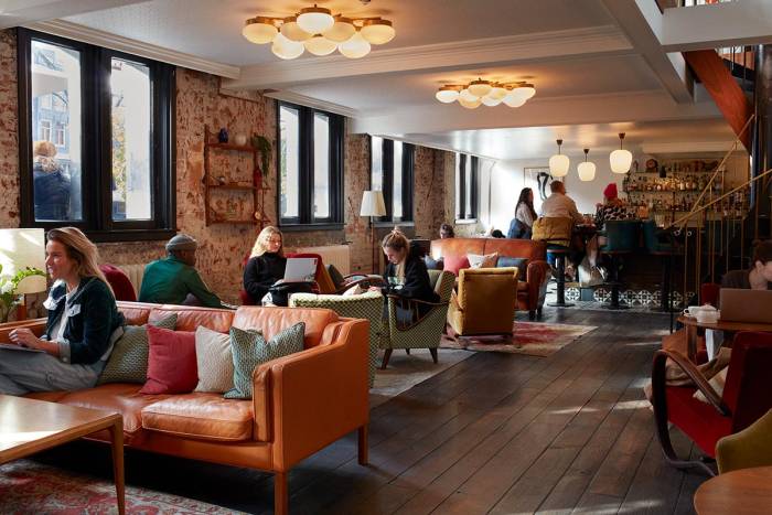 Lobby with colourful sofas and wooden floor.