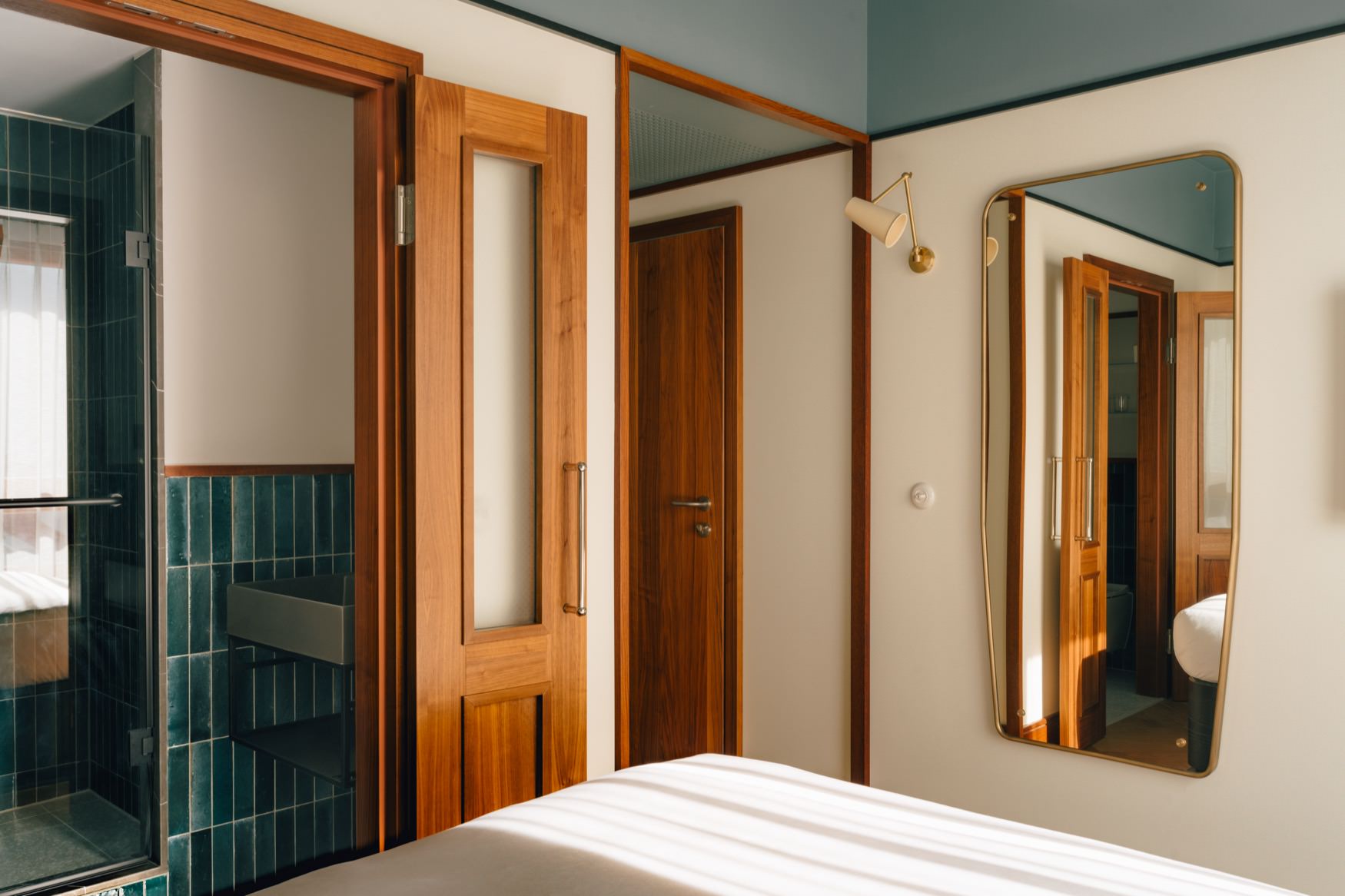 View of end of bed and entrance to the bathroom.