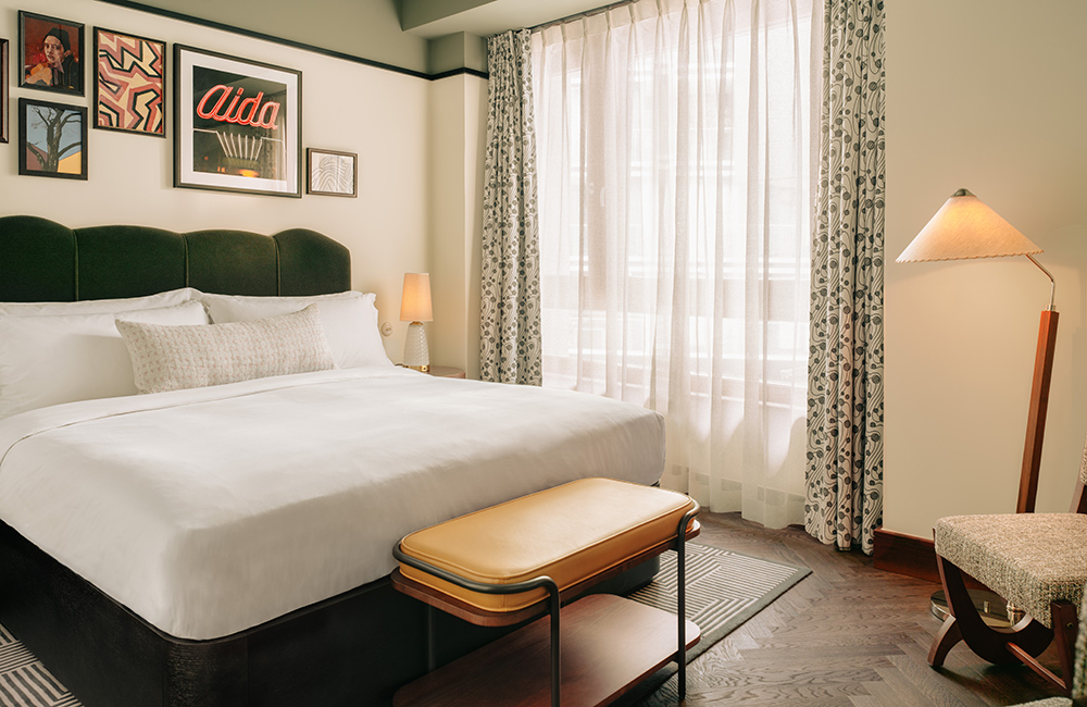 Roomy room with soft light and art on the walls above the headboard of the comfy bed.