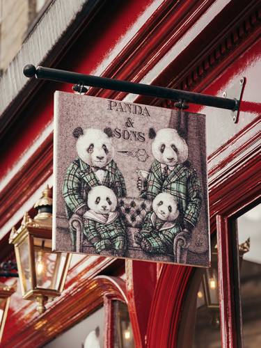 The store sign of Panda & Sons, showing 4 pandas.