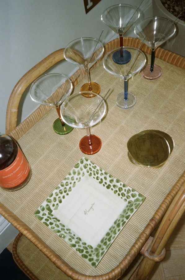 Photos by Nic Ford.Raffia drink trolley with six cocktail glasses, brass coasters, and trinket dish.- The Localist, Hoxton Hotels.